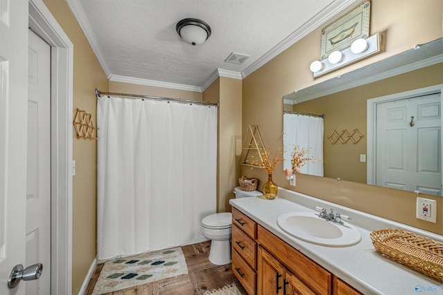 bathroom featuring toilet, vanity, crown molding, hardwood / wood-style flooring, and a textured ceiling