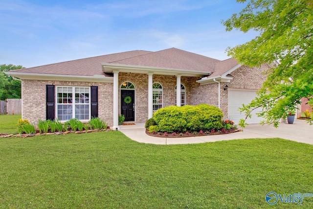 ranch-style home featuring a front lawn, brick siding, a shingled roof, concrete driveway, and an attached garage