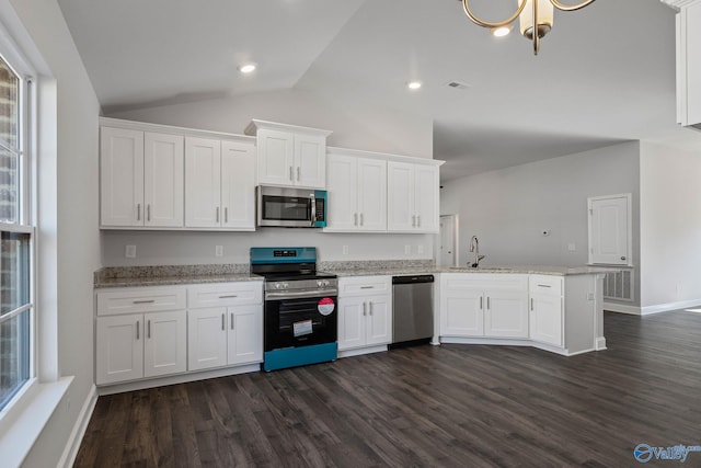 kitchen with white cabinetry, stainless steel appliances, and dark wood finished floors