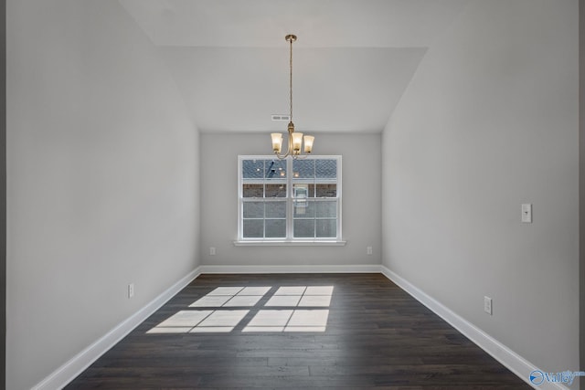 unfurnished dining area with an inviting chandelier, baseboards, visible vents, and dark wood finished floors