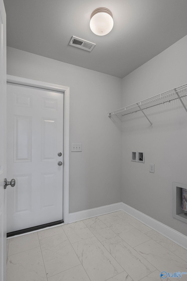 clothes washing area with washer hookup, marble finish floor, visible vents, laundry area, and baseboards