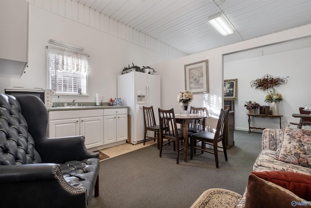 carpeted dining area with sink