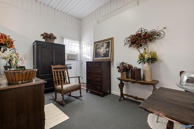 living area with cooling unit and dark carpet