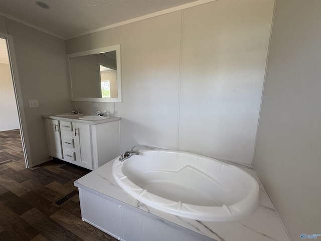 bathroom featuring a sink, a bath, double vanity, and wood finished floors