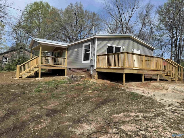 back of property with stairs and a deck