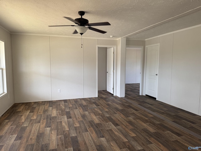 empty room with ornamental molding, a ceiling fan, wood finished floors, and a textured ceiling