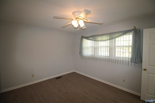 empty room with ceiling fan and dark hardwood / wood-style floors