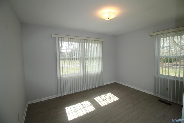 unfurnished room featuring dark wood-type flooring