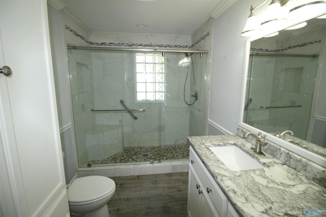 bathroom with toilet, hardwood / wood-style flooring, a shower with shower door, and vanity