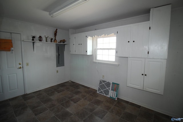 interior space featuring electric panel and cabinets