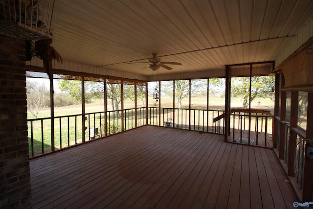 unfurnished sunroom with ceiling fan and wood ceiling