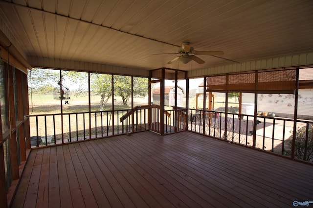 unfurnished sunroom featuring ceiling fan