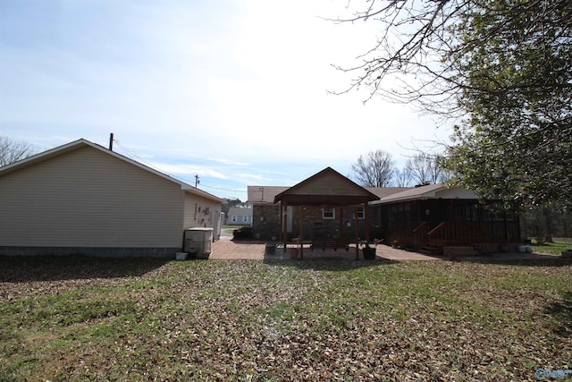 back of property with a lawn and a patio area