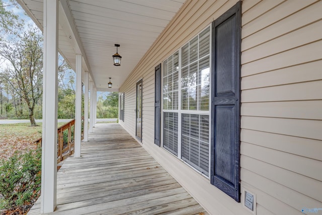 wooden terrace featuring covered porch