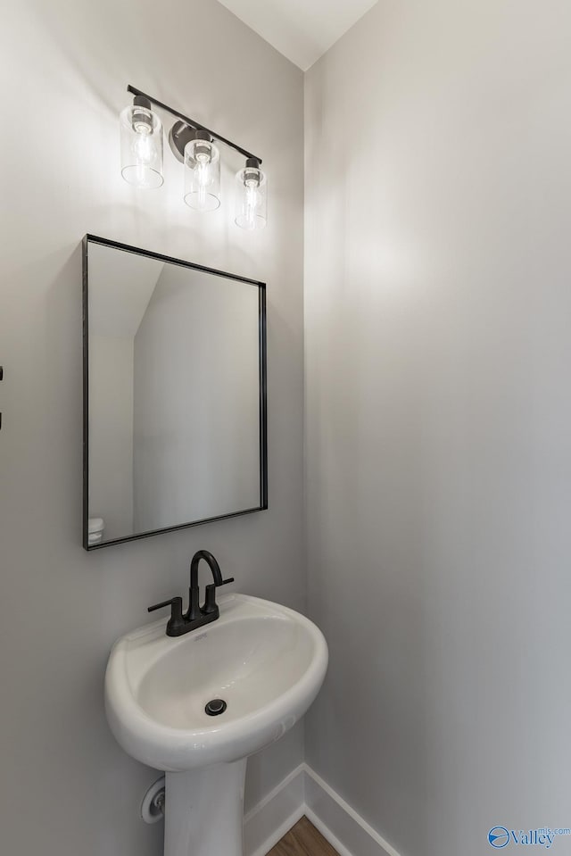 1201 Halsey Ave, Huntsville, AL 35801 - bathroom with a sink, baseboards, and wood finished floors