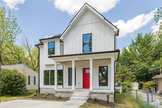 1201 Halsey Ave, Huntsville, AL 35801 - modern farmhouse style home with board and batten siding, a porch, and fence