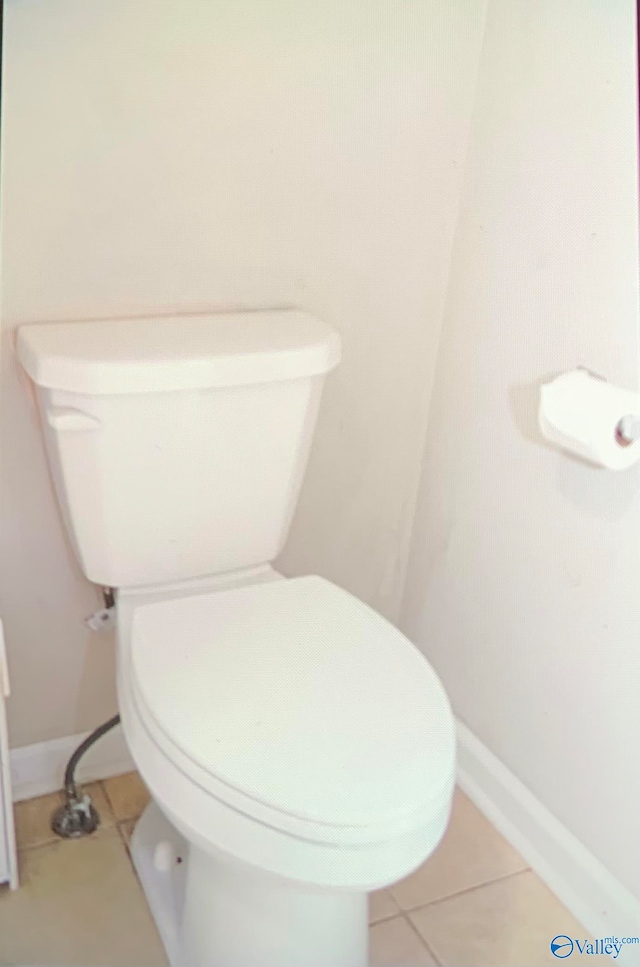 bathroom featuring toilet and tile patterned flooring