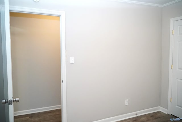 interior space featuring dark hardwood / wood-style floors and crown molding