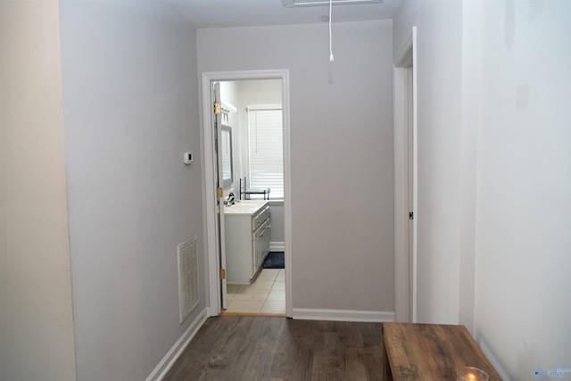 hallway featuring light hardwood / wood-style floors and sink