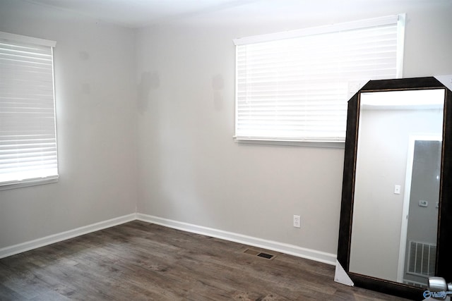 unfurnished room featuring dark hardwood / wood-style floors