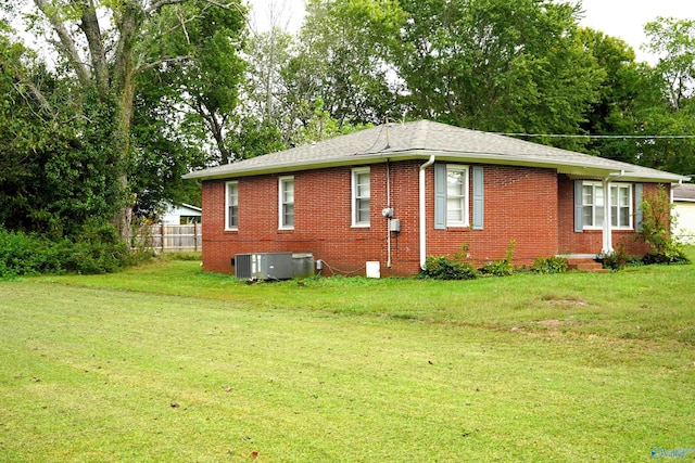 exterior space with a lawn and central AC