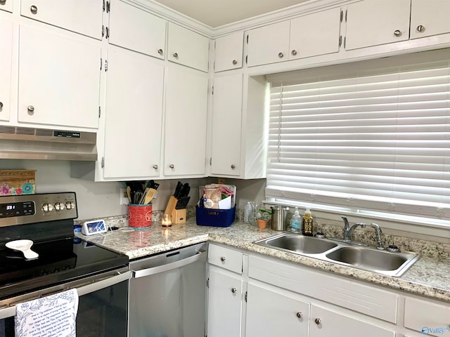 kitchen with white cabinets, appliances with stainless steel finishes, sink, and extractor fan