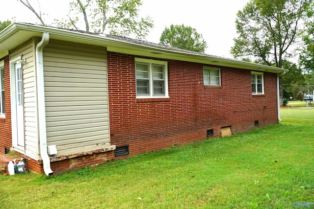 view of side of home featuring a lawn