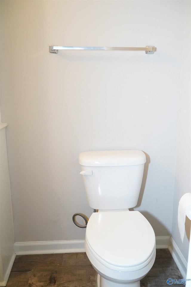 bathroom featuring wood-type flooring and toilet