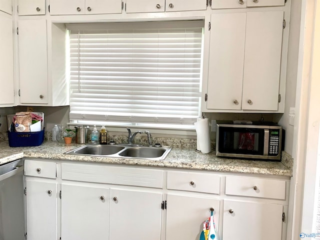 kitchen with sink, stainless steel appliances, and white cabinets