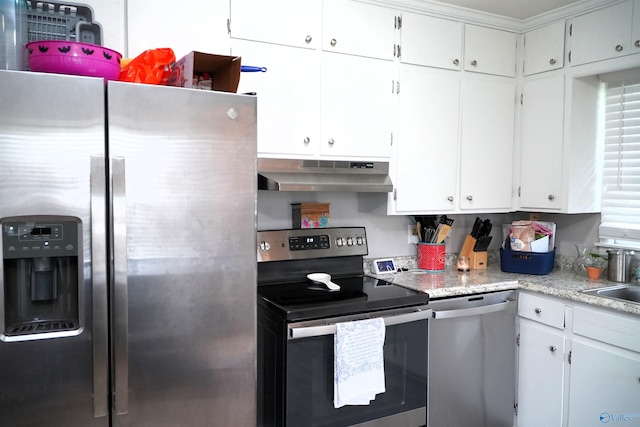 kitchen with exhaust hood, appliances with stainless steel finishes, and white cabinetry