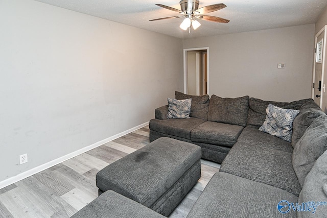 living room featuring ceiling fan and light wood-type flooring