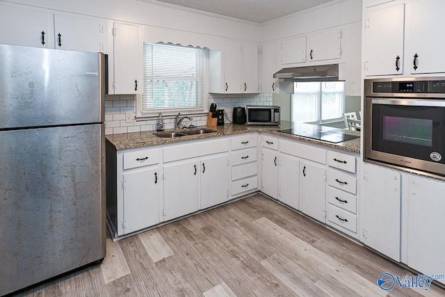 kitchen featuring white cabinetry, appliances with stainless steel finishes, sink, and light hardwood / wood-style flooring