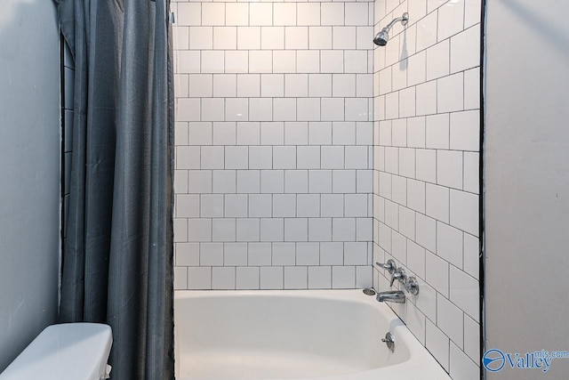 bathroom with shower / tub combo and toilet