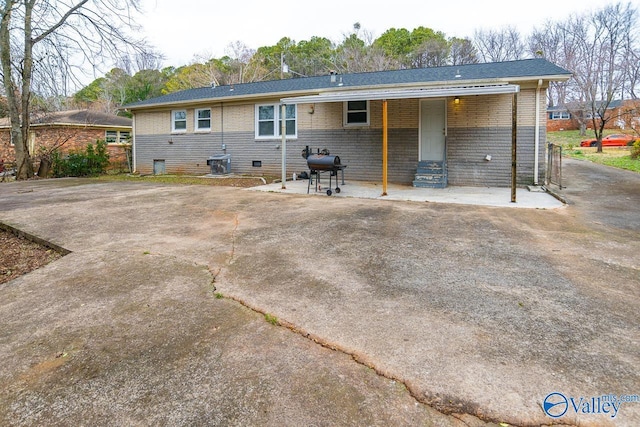 rear view of property featuring a patio area