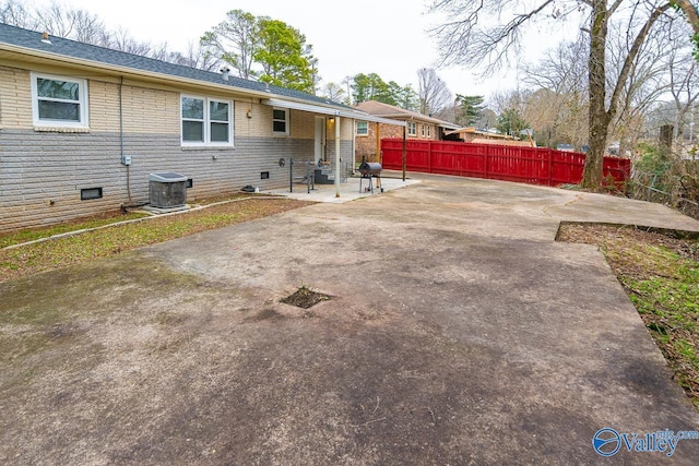 rear view of property featuring central air condition unit and a patio area