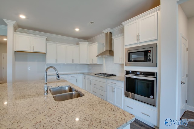 kitchen with white cabinets, stainless steel appliances, wall chimney exhaust hood, and sink