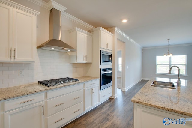 kitchen with white cabinetry, stainless steel appliances, sink, dark hardwood / wood-style floors, and wall chimney range hood