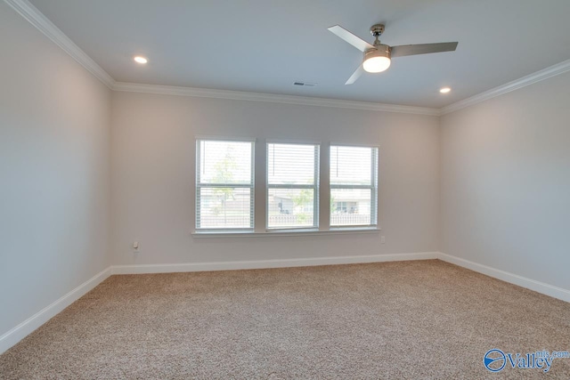 unfurnished room featuring crown molding, ceiling fan, and carpet