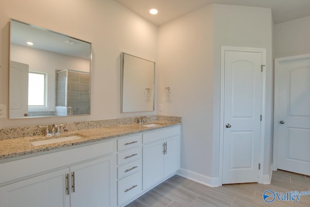 bathroom featuring vanity, hardwood / wood-style flooring, and walk in shower