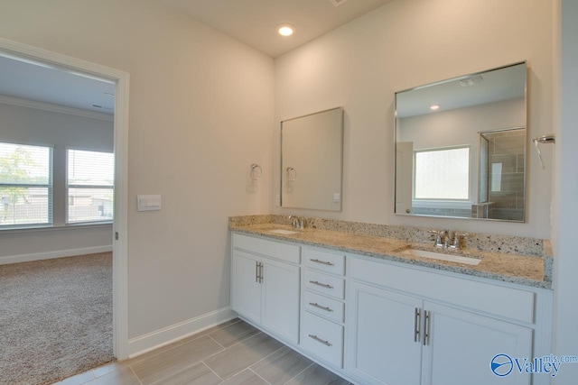 bathroom with crown molding and vanity