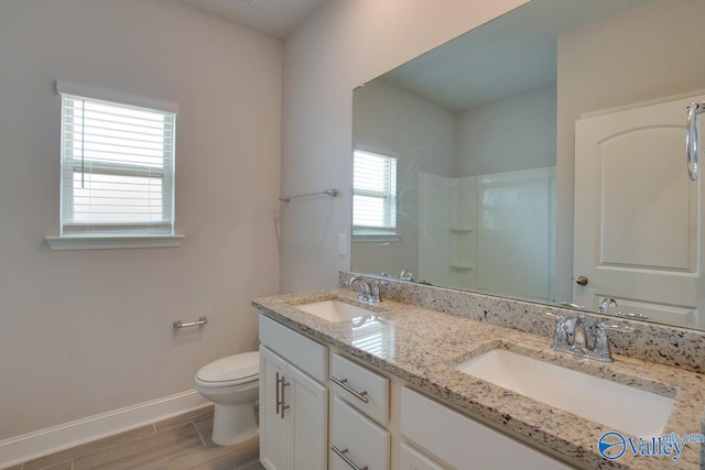 bathroom featuring vanity, toilet, walk in shower, and hardwood / wood-style floors