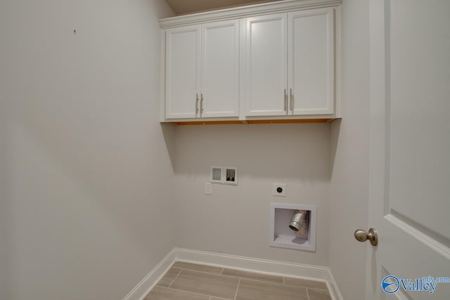 laundry room featuring washer hookup, cabinets, electric dryer hookup, and light hardwood / wood-style flooring