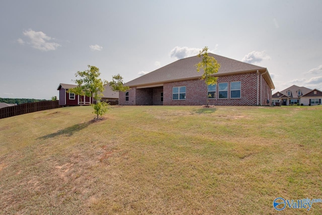 rear view of property with a yard