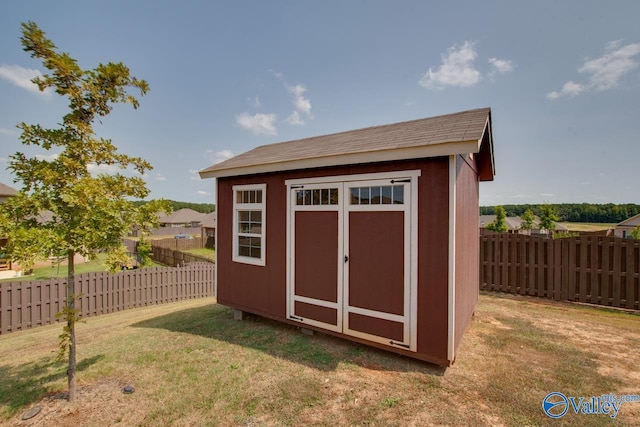 view of outbuilding with a yard