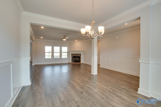 unfurnished living room with ornamental molding, a stone fireplace, and hardwood / wood-style flooring