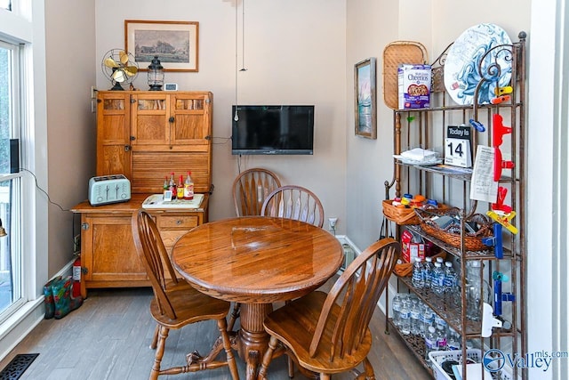 dining room with visible vents, baseboards, and wood finished floors