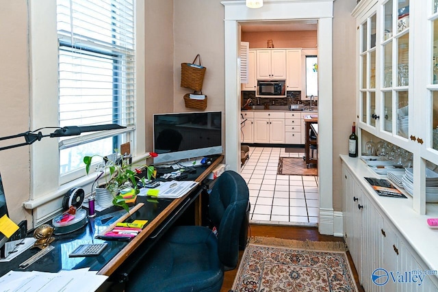 interior space featuring tile patterned floors and a sink