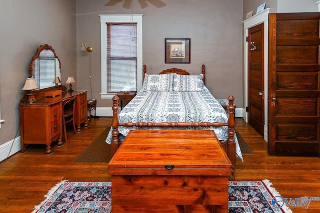 bedroom with ceiling fan, baseboards, and dark wood finished floors