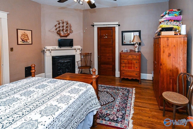 bedroom with baseboards and wood finished floors