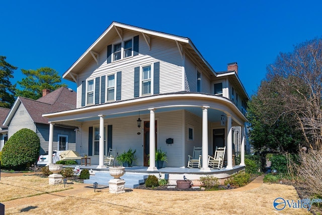 view of front of home with a porch and a chimney